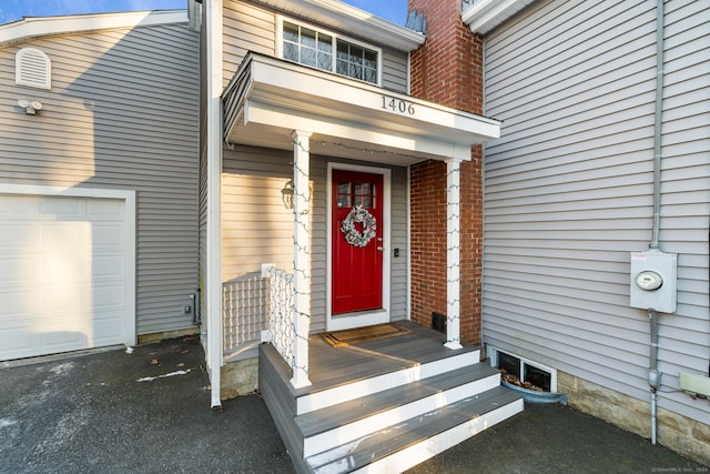 doorway to property with a garage