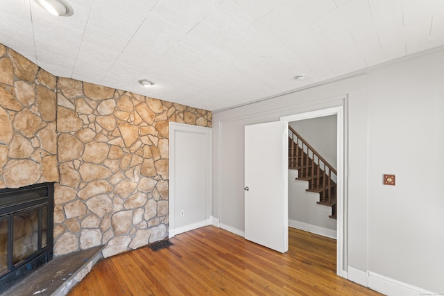 unfurnished living room with hardwood / wood-style flooring and a fireplace