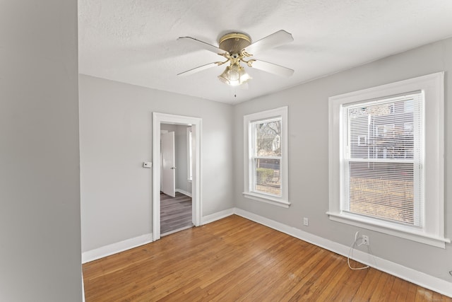 empty room with wood-type flooring and ceiling fan