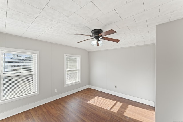 unfurnished room featuring a wealth of natural light, ceiling fan, and hardwood / wood-style flooring