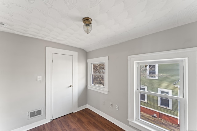 empty room with dark wood-type flooring