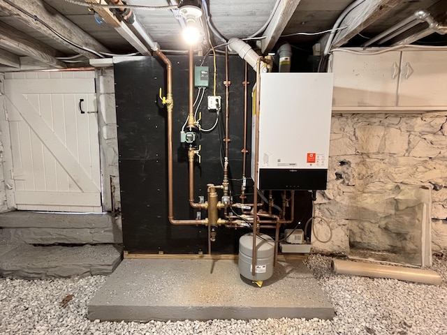 utility room featuring water heater