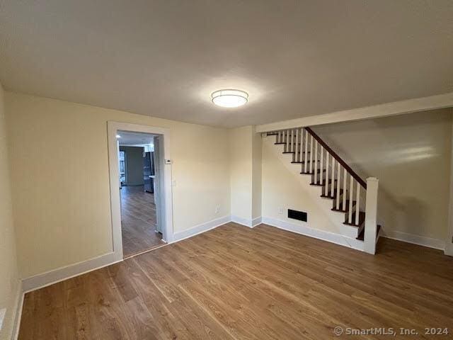 empty room with hardwood / wood-style flooring