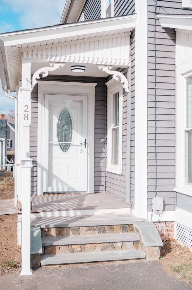 view of exterior entry with covered porch