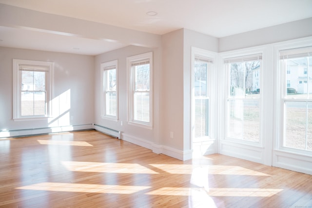 doorway to outside featuring light wood-type flooring and baseboards