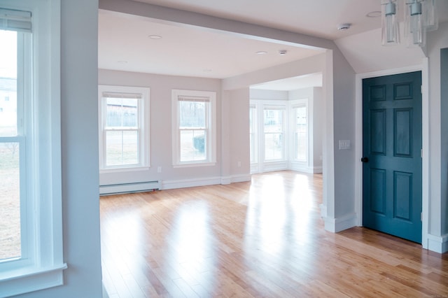 entryway featuring baseboards, baseboard heating, and light wood-style floors