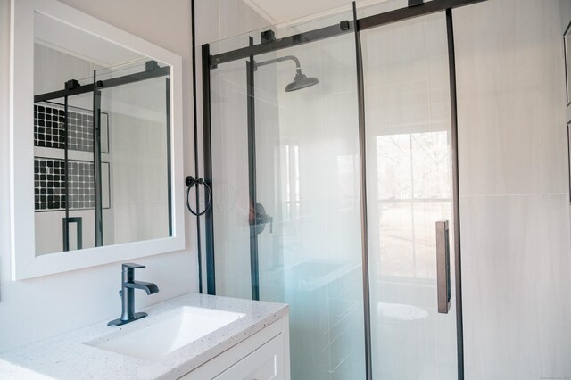 bathroom featuring vanity and a shower with shower door