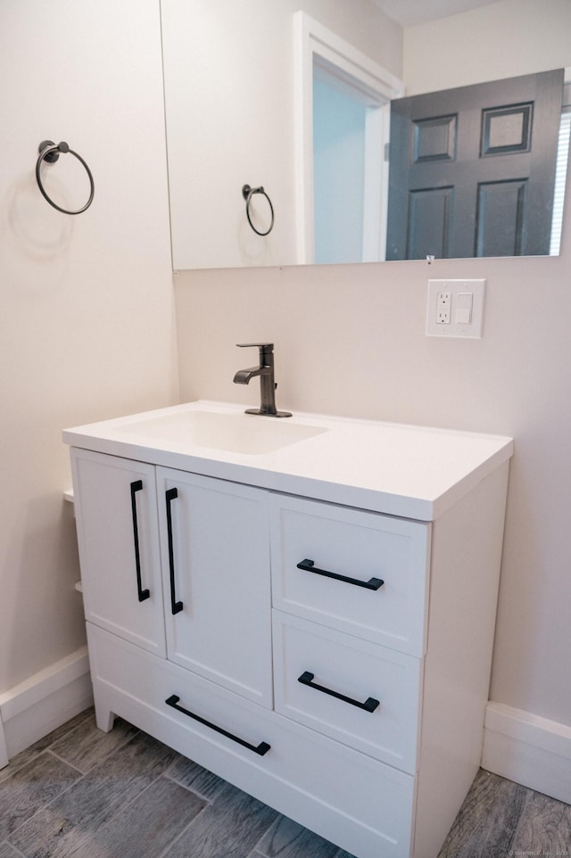 bathroom with vanity and wood-type flooring