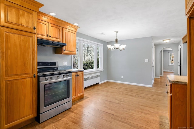 kitchen with decorative light fixtures, gas range, a notable chandelier, light hardwood / wood-style floors, and radiator heating unit