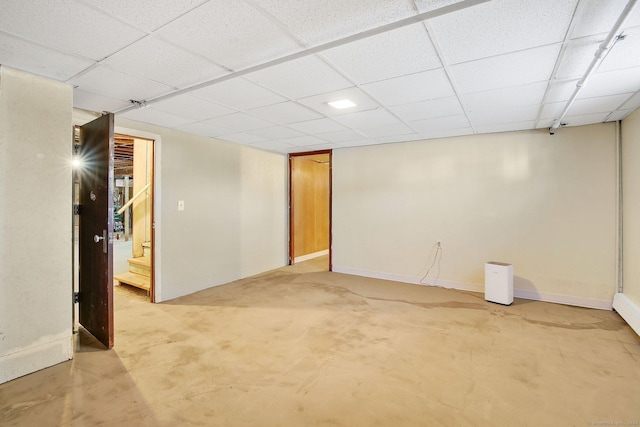 basement with a paneled ceiling