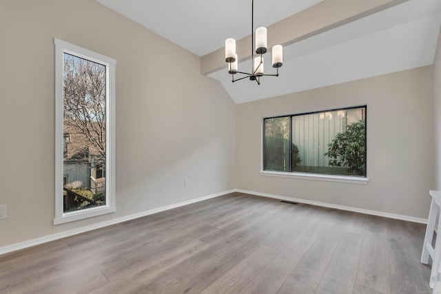 empty room with wood-type flooring, lofted ceiling with beams, and a notable chandelier