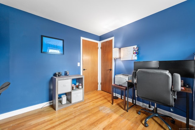 office with light wood-type flooring