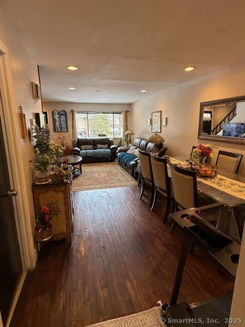 living room with dark wood-style flooring and recessed lighting