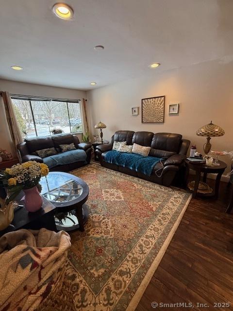 living area with dark wood finished floors and recessed lighting