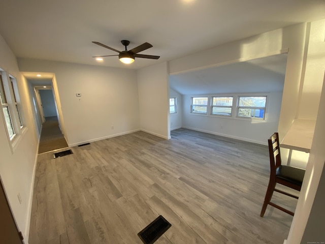 unfurnished living room with hardwood / wood-style floors, ceiling fan, and lofted ceiling