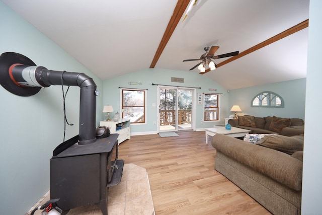 living room with vaulted ceiling with beams, ceiling fan, and light hardwood / wood-style flooring