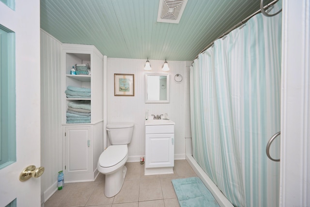 bathroom with tile patterned flooring, vanity, curtained shower, and toilet