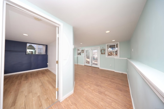 hallway featuring french doors and light wood-type flooring