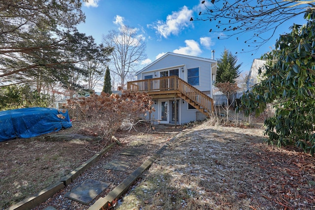 rear view of house featuring a wooden deck