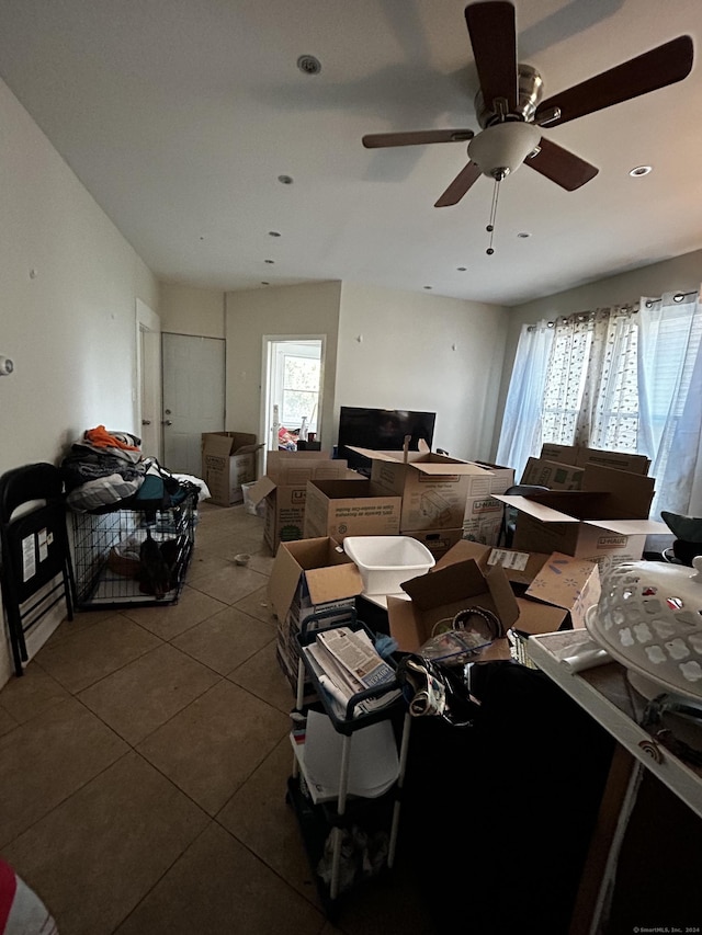 interior space featuring tile patterned floors, ceiling fan, and a healthy amount of sunlight