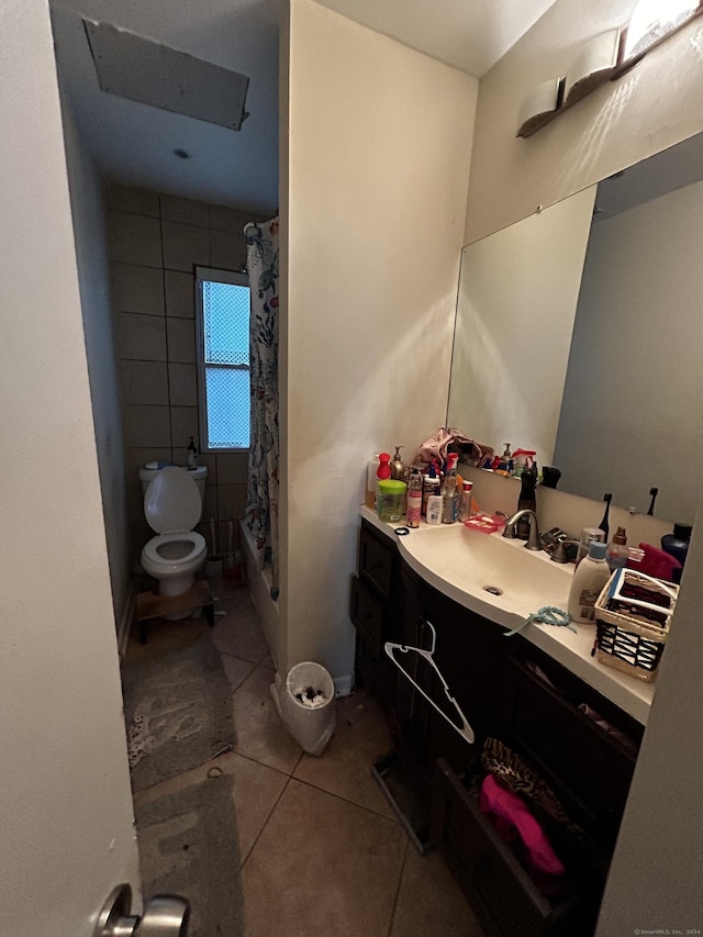 bathroom with tile patterned flooring, vanity, and toilet