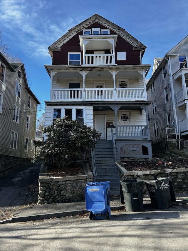 view of front of property with covered porch and a balcony