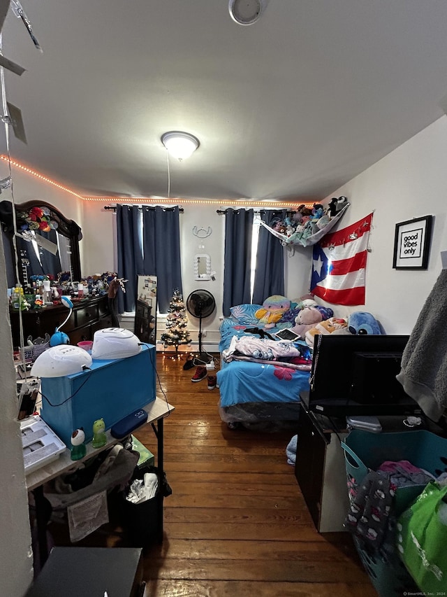 bedroom with dark hardwood / wood-style floors