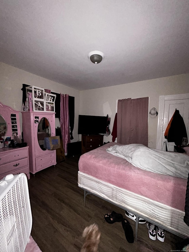 bedroom with dark hardwood / wood-style floors