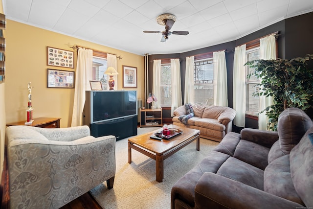 living room with ceiling fan and crown molding