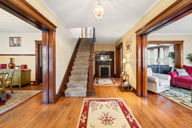 interior space with ornamental molding and light hardwood / wood-style flooring