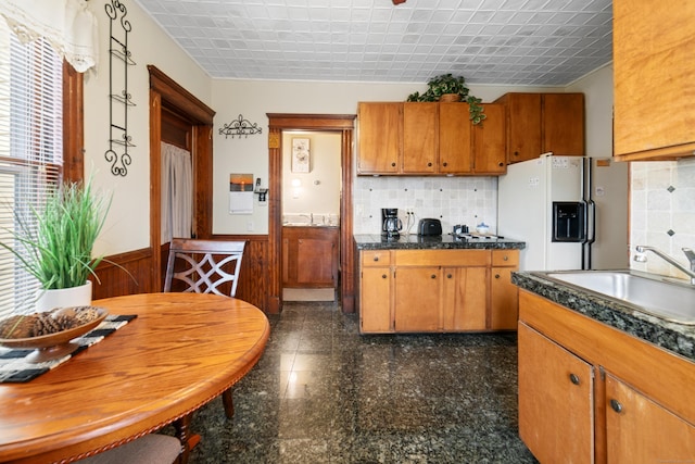 kitchen with white fridge with ice dispenser and sink