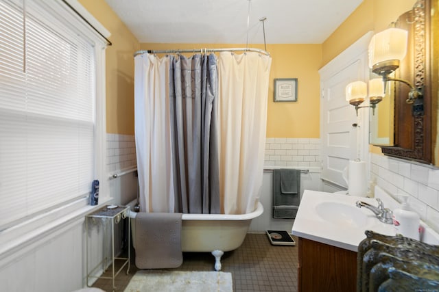 bathroom featuring shower / tub combo, tile patterned flooring, vanity, and tile walls