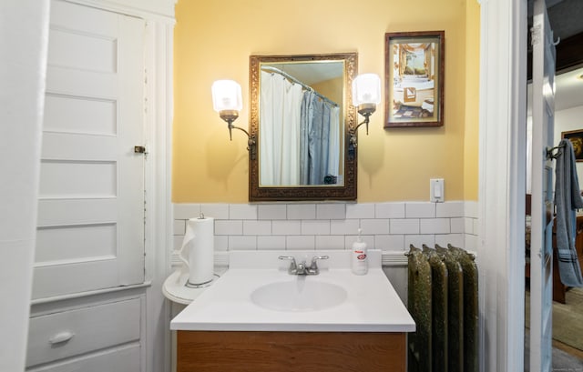 bathroom with radiator heating unit and vanity