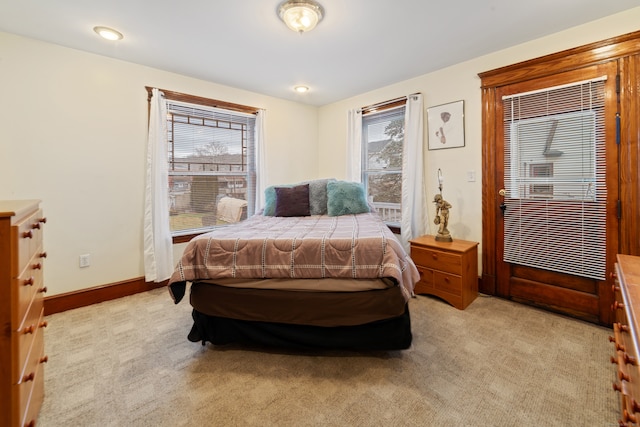 carpeted bedroom with multiple windows