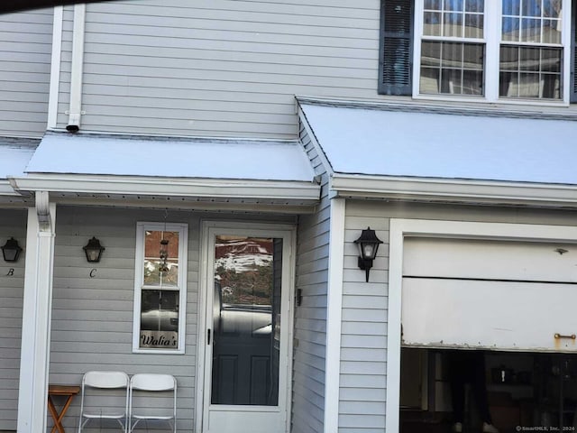 view of exterior entry with a garage