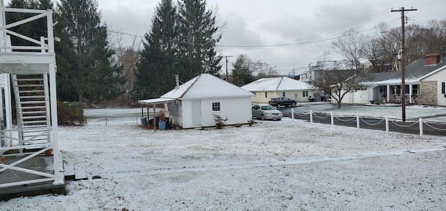 yard layered in snow featuring an outbuilding