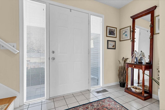 foyer entrance with light tile patterned floors