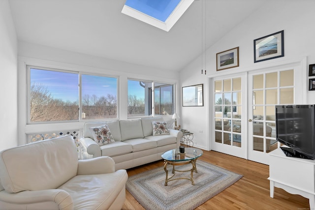 sunroom featuring french doors and lofted ceiling with skylight