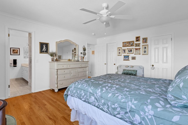 bedroom featuring crown molding, ensuite bath, ceiling fan, and light wood-type flooring