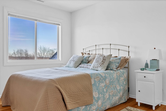 bedroom with hardwood / wood-style flooring