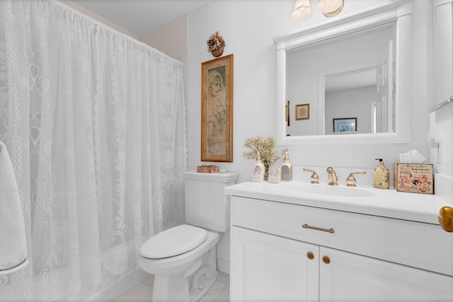 bathroom featuring toilet, vanity, and walk in shower