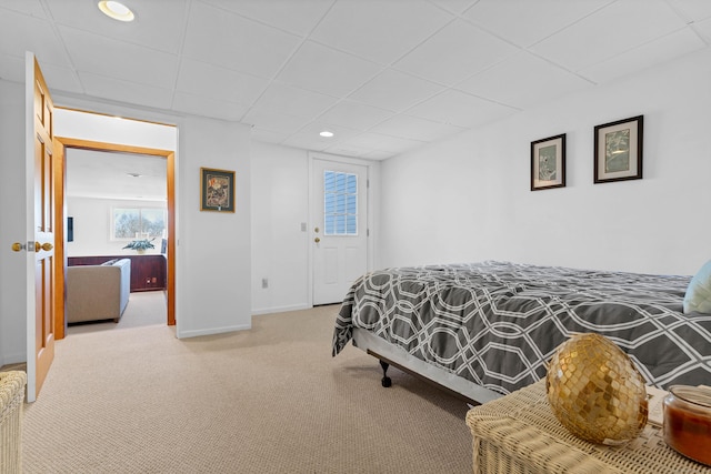 bedroom with a paneled ceiling and carpet