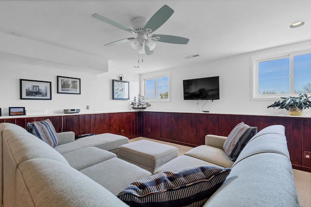 living room with light carpet and ceiling fan