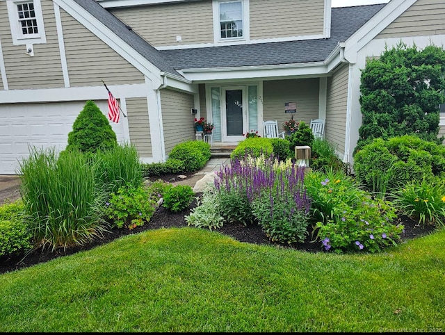 view of exterior entry featuring a lawn