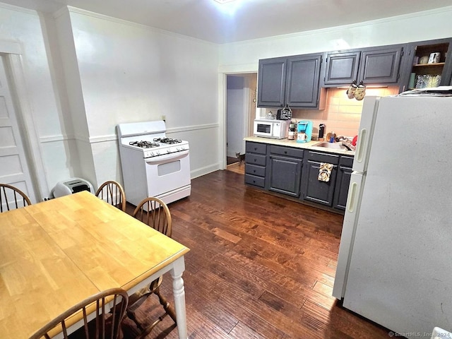 kitchen featuring dark hardwood / wood-style floors, gray cabinets, white appliances, and tasteful backsplash