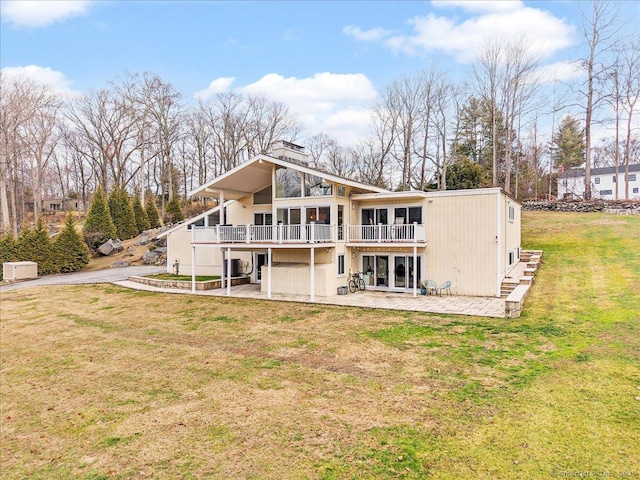 back of property featuring a patio area, a yard, and a deck