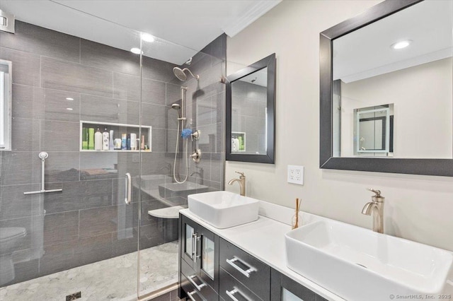 bathroom with a shower with door, vanity, and toilet