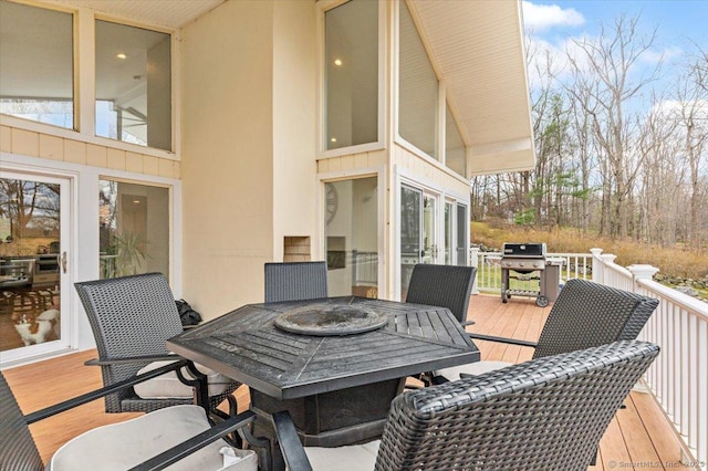 wooden terrace featuring a grill