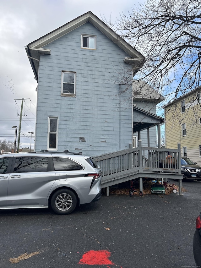 view of home's exterior with a wooden deck