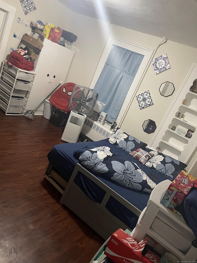 bedroom with dark hardwood / wood-style flooring